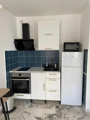a kitchen with a white refrigerator and a sink at Studio 50 m de la mer - Centre - Proche mer in Nice