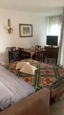 a bedroom with a bed and a table and a television at Acquamarina - vue mer in Nice
