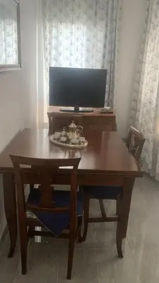 a wooden table with a television on top of it at Acquamarina - vue mer in Nice