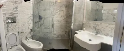 a bathroom with a toilet and a sink and a shower at Acquamarina - vue mer in Nice