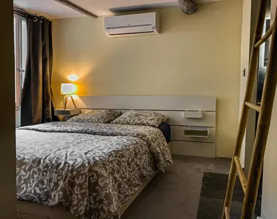a bedroom with two beds in a room at Duplex, jacuzzi, terrasse sur les toits in Nice