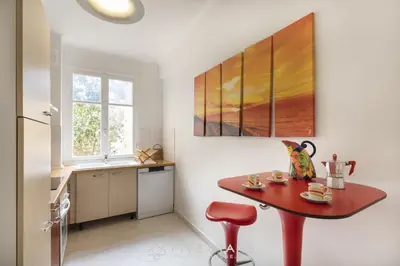 a kitchen with a red table and a red stool at Suite Flora Five stars Holiday house in Nice