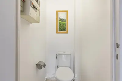 a bathroom with a toilet with a picture on the wall at Suite Flora Five stars Holiday house in Nice