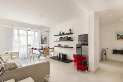 a living room with a couch and a table at Suite Flora Five stars Holiday house in Nice