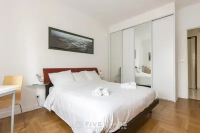 a bedroom with a bed with two towels on it at Suite Flora Five stars Holiday house in Nice