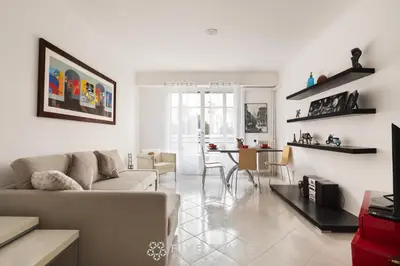 a living room with a couch and a table at Suite Flora Five stars Holiday house in Nice