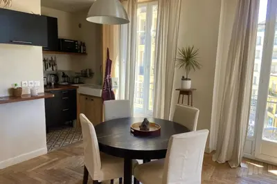a kitchen and dining room with a table and chairs at Nice 56m with balcony in rotunda near the sea in Nice