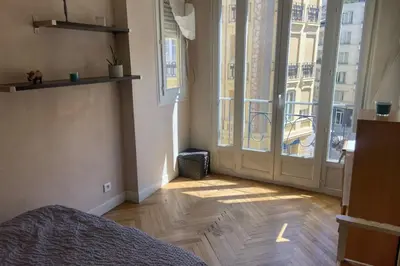 a bedroom with a bed and a large window at Nice 56m with balcony in rotunda near the sea in Nice