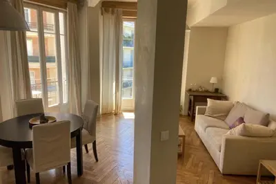 a living room with a white couch and a table at Nice 56m with balcony in rotunda near the sea in Nice