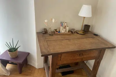 a wooden desk with a lamp and a plant on it at Nice 56m with balcony in rotunda near the sea in Nice