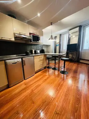 a kitchen with a table and chairs in it at Vieux Nice 2 pièces Appartement MONACO in Nice