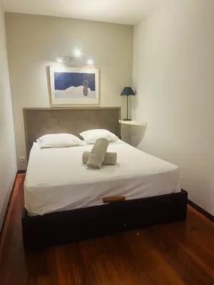 a bedroom with a large bed with white sheets at Vieux Nice 2 pièces Appartement MONACO in Nice