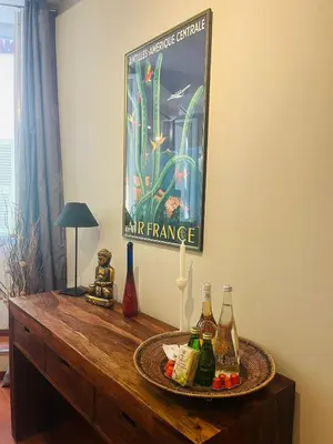 a table with a picture on the wall at Vieux Nice 2 pièces Appartement MONACO in Nice