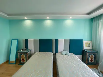 a room with two beds and two night stands at Cagnes-sur-Mer, 50m de la mer, au calme in Cagnes-sur-Mer