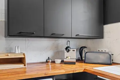 a kitchen with black cabinets and a wooden counter top at Nice Renting - BELLET - Live A Dream Villa Pool 3 Bedroom Garden Parking in Nice