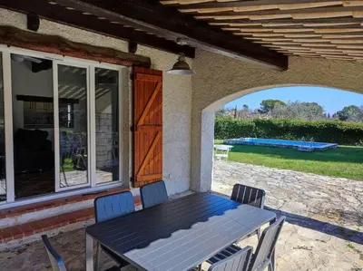 a table and chairs sitting on a porch with a view at Villa Olivaie St Ange in La Gaude