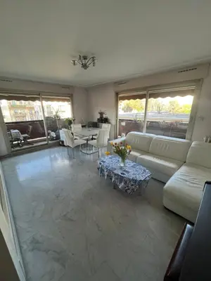 a living room with a couch and a table at Chambre privée avec terrasse au port de Nice in Nice