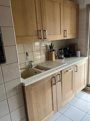 a kitchen with wooden cabinets and a sink at Chambre privée avec terrasse au port de Nice in Nice
