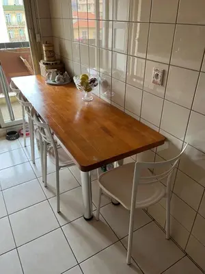 a wooden table and chairs in a room at Chambre privée avec terrasse au port de Nice in Nice