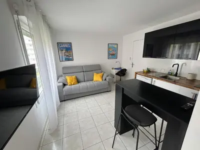 a living room with a couch and a table at Magnifique studio au bord de mer in Nice