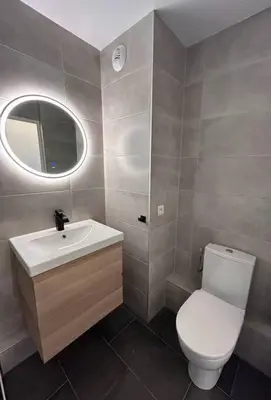 a bathroom with a toilet and a sink and a mirror at Magnifique studio au bord de mer in Nice