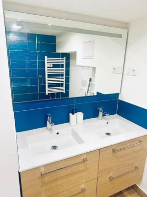 a bathroom with a white sink and a mirror at T3 carré d’or plein centre in Nice