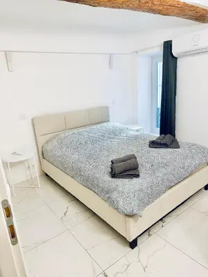 a bedroom with a bed with two towels on it at T3 carré d’or plein centre in Nice