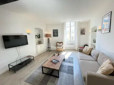 a living room with a couch and a coffee table at Nice Renting - BONAPARTE - Luxury Loft Trendy neighborhood - AC - fully equipped in Nice