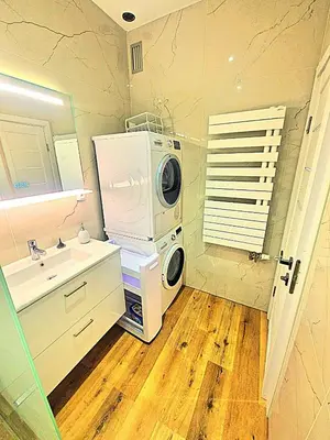 a bathroom with a washing machine and a sink at NissaLaBella in Nice
