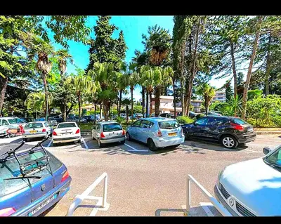 a bunch of cars parked in a parking lot at NissaLaBella in Nice