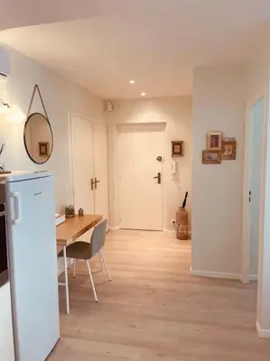a kitchen and dining room with a table and a mirror at Appartement Carré d’Or Nice in Nice