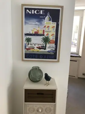 a picture hanging on a wall with a bird on a table at LA FONTAINE AP4355 By Riviera Holiday Homes in Villefranche-sur-Mer