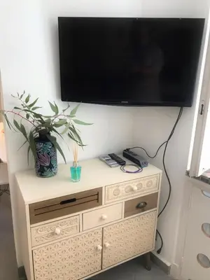 a tv on top of a wooden dresser at LA FONTAINE AP4355 By Riviera Holiday Homes in Villefranche-sur-Mer
