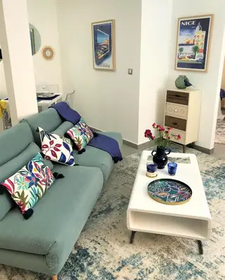 a living room with a couch and a table at LA FONTAINE AP4355 By Riviera Holiday Homes in Villefranche-sur-Mer