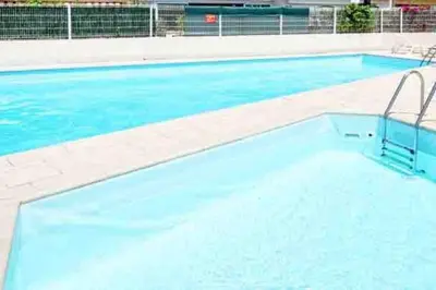 a large swimming pool with blue water at Superbe appartement avec piscine l'été de juin à septembre in Nice