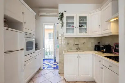 a kitchen with white cabinets and a sink at Suite La bohème Five stars Holiday house in Nice