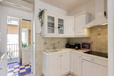 a kitchen with white cabinets and a sink at Suite La bohème Five stars Holiday house in Nice