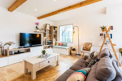 a living room with a couch and a tv at LA CASITA VI4348 By Riviera Holiday HOmes in Falicon