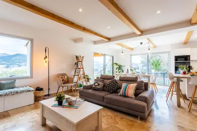 a living room with a couch and a table at LA CASITA VI4348 By Riviera Holiday HOmes in Falicon