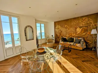 a living room with a table and a couch at Happyfew Palazzo del sol in Nice