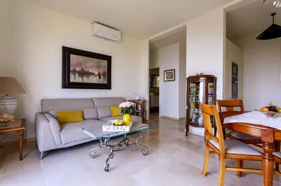 a living room with a couch and a table at Sea View Apartment with Private Secure Parking - 2 in Villefranche-sur-Mer