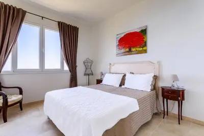 a bedroom with a white bed and a window at Sea View Apartment with Private Secure Parking - 2 in Villefranche-sur-Mer