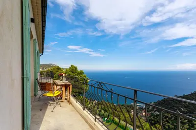 a balcony with a table and a view of the ocean at Sea View Apartment with Private Secure Parking 3 in Villefranche-sur-Mer