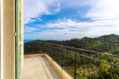 a balcony with a view of the mountains at Sea View Apartment with Private Secure Parking 3 in Villefranche-sur-Mer