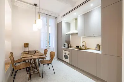 a kitchen with a table and chairs in a room at Chez Collette - Luxury in the Old Nice in Nice