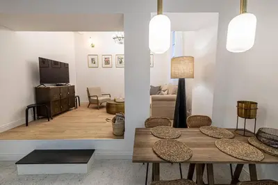 a living room with a table and chairs and a television at Chez Collette - Luxury in the Old Nice in Nice