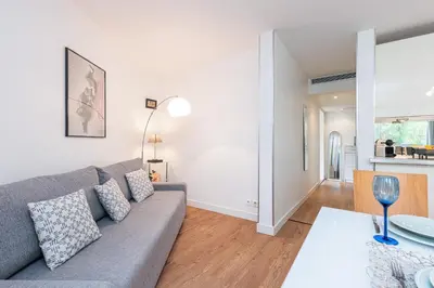 a living room with a couch and a table at Central 1 Bdr in Nice