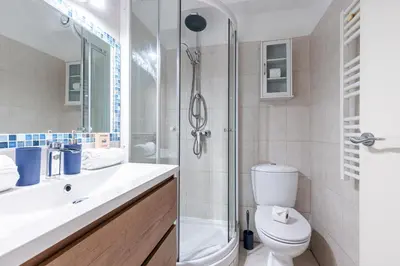 a bathroom with a shower and a toilet and a sink at Central 1 Bdr in Nice