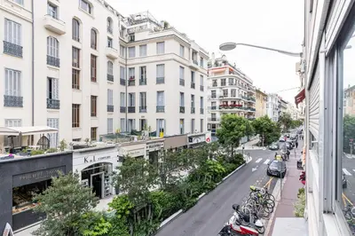 a city street with parked cars and buildings at Central 1 Bdr in Nice