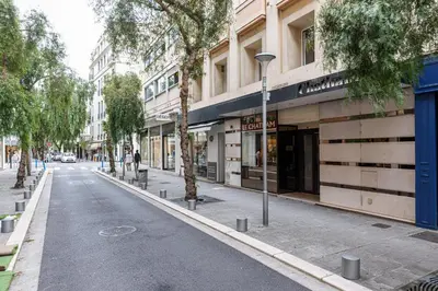 an empty street in front of a building at Central 1 Bdr in Nice